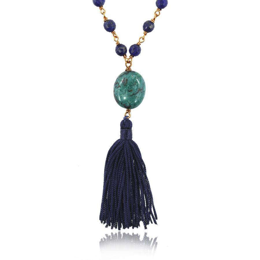 turquoise pendant and dark blue tassel of a mala necklace on white background