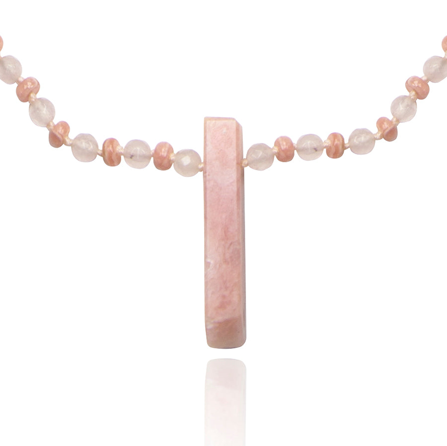 pink opal pendant of a short necklace on white background