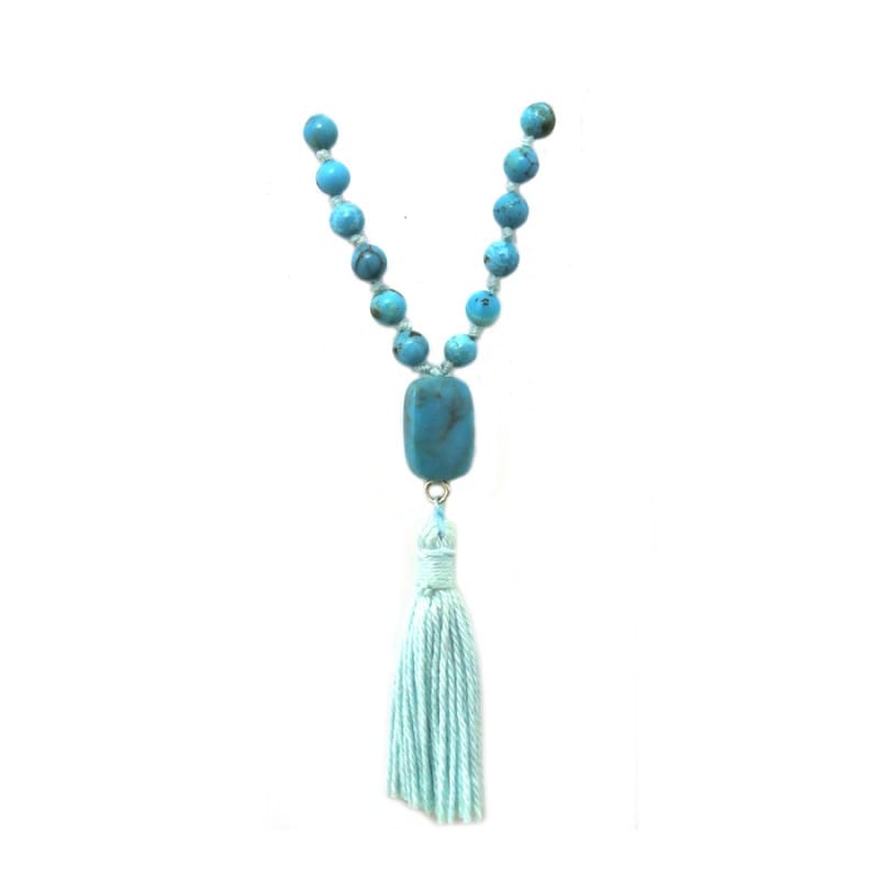 turquoise pendant with light blue tassel on white background