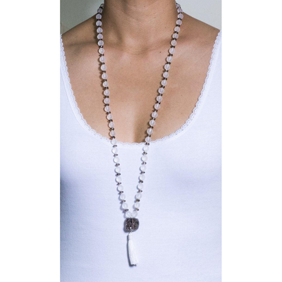 mala necklace with 8 mm round frosted crystals alternated with smokey quartz and smokey quartz pendant and white tassle on model