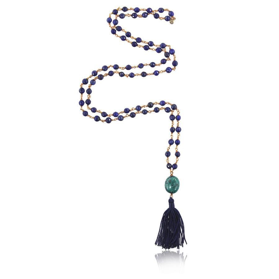 a mala necklace with 72 pieces of faceted 6mm lapis lazuli beads strung with copper wire with turquoise pendant and dark blue tassel on white background