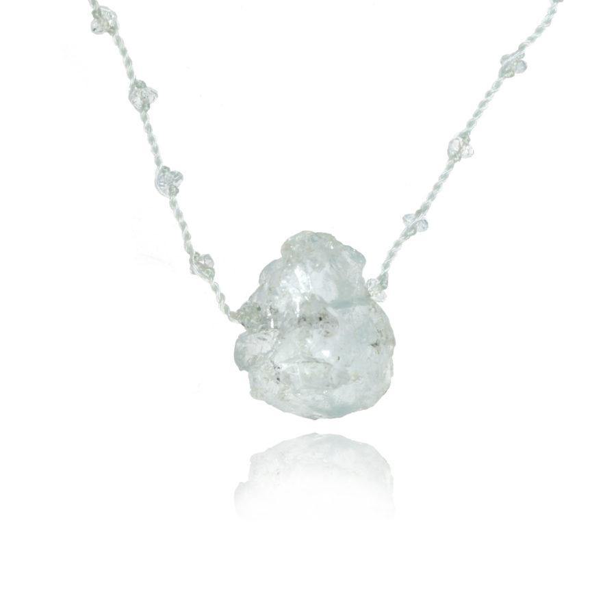 a raw Aquamarine centerpiece of a short aquamarine pendant necklace on white background