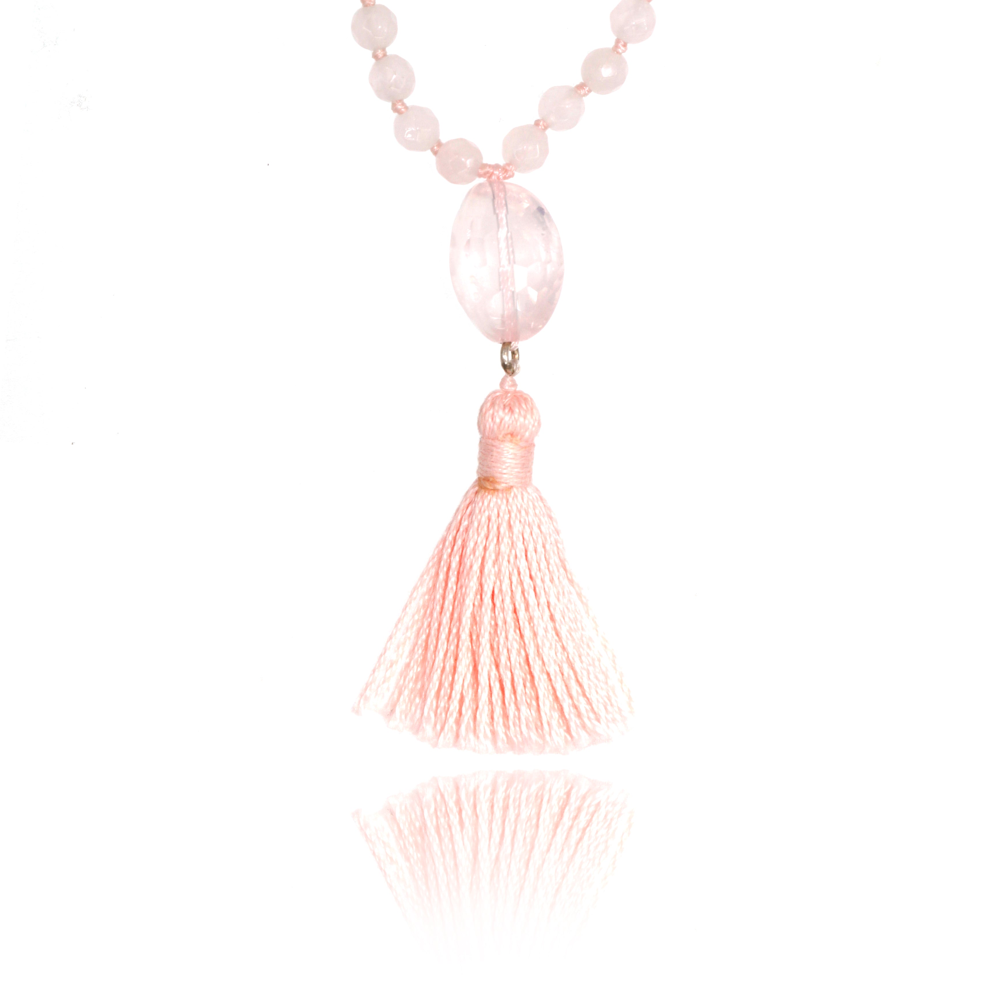 rose quartz pendant and light pink tassel of a mala baby nekclace on white background