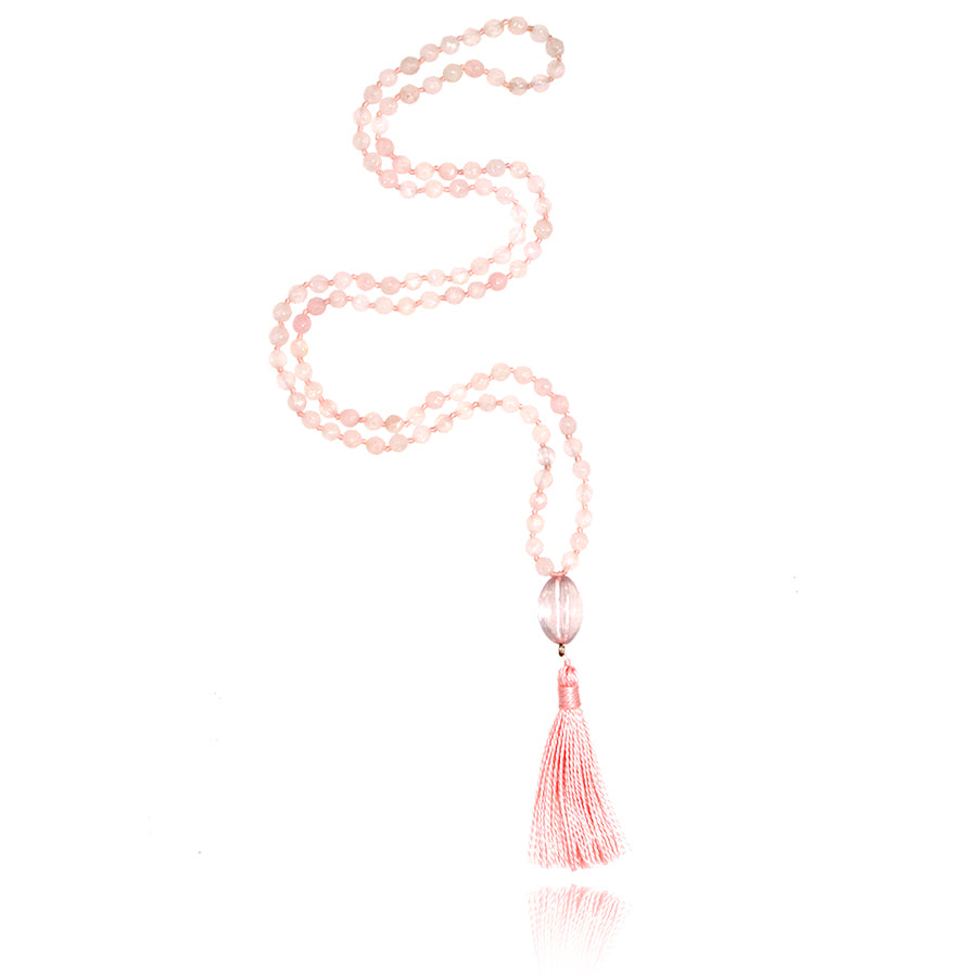 mala baby necklace with 108 pieces of 4mm faceted rose quartz beads with rose quartz pendant and light pink tassel on white background