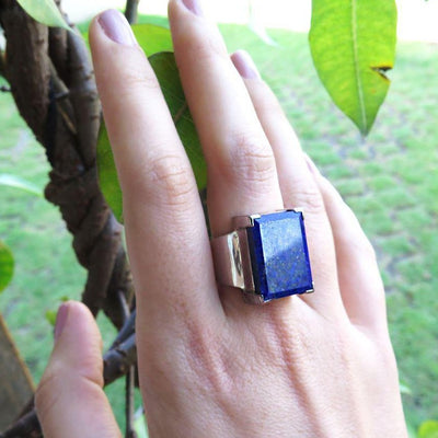 silver ring with rectangular lapis lazuli stone on hand