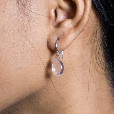 a silver earrings with rose quartz drop on model