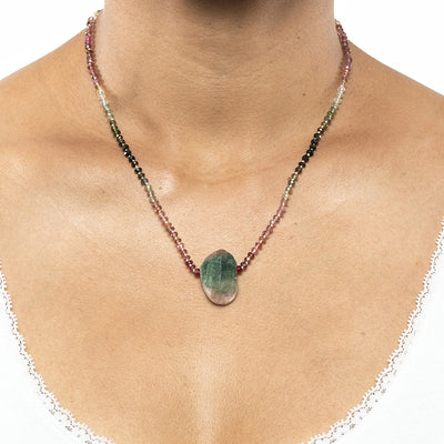 short necklace with Faceted Watermelon Tourmaline beads and raw tourmaline pendant with silver 925 chain extender on model in white top