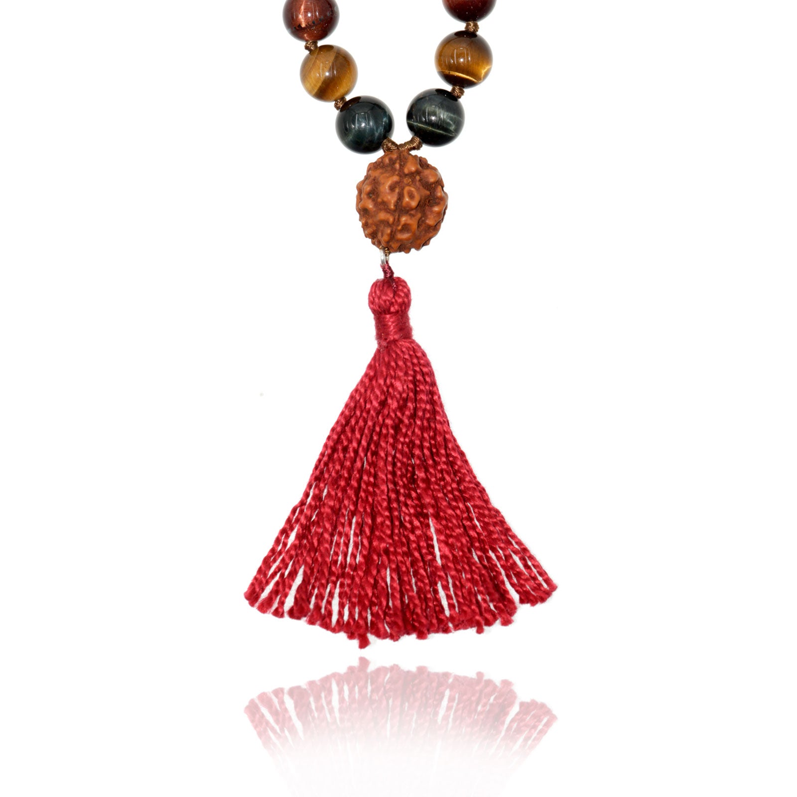 rudraksha and red tassel of a mala necklace on white background