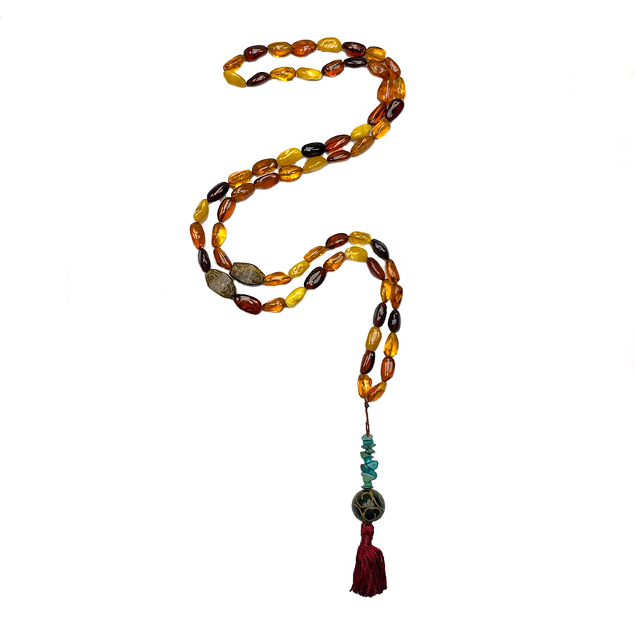 tibetan mala necklace with 63 beads of Amber and Turquoise and Chinese Jade with dark red short tassel on white background