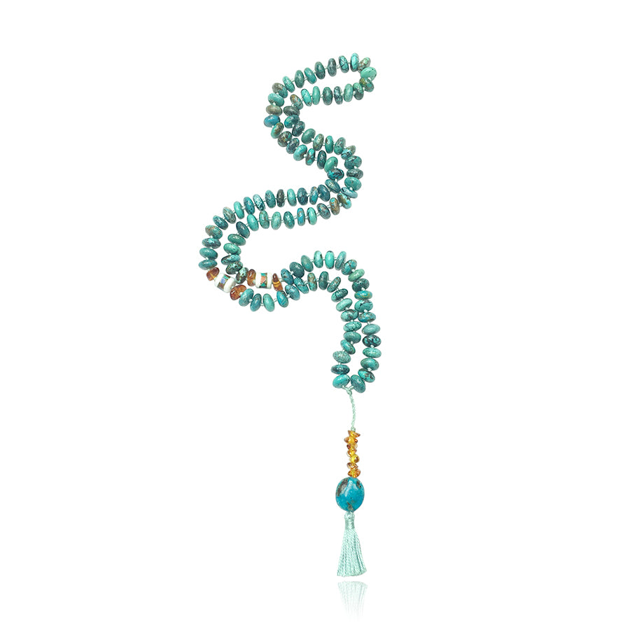 turquoise, amber, tibetan beads mala necklace with amber and turquoise pendant with light blue tassle on white background