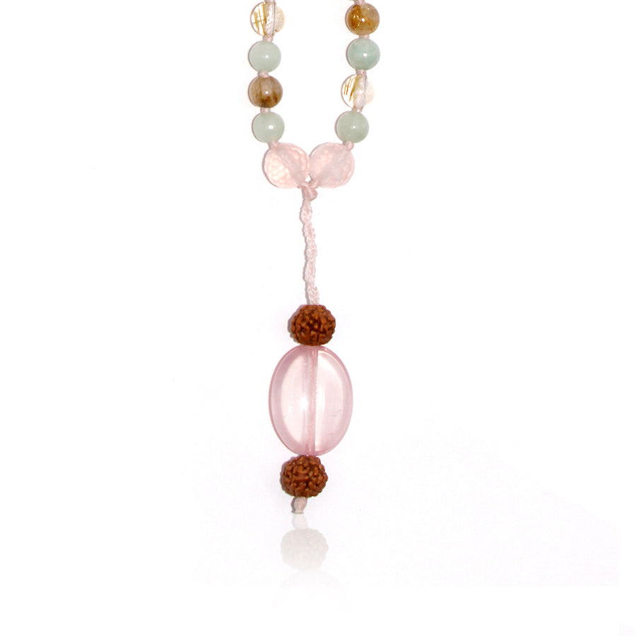 rudraksha and rose quartz pendant of a mala necklace on white background