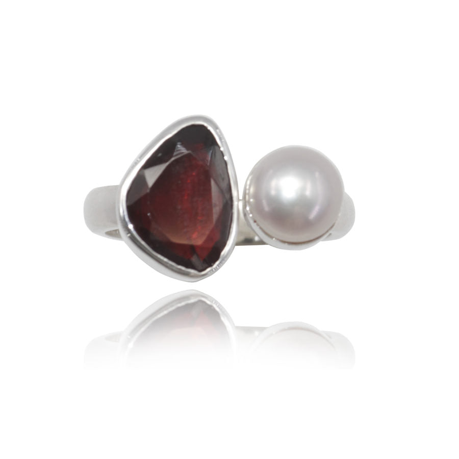 silver ring with garnet and pearl set in silver 925 on white background