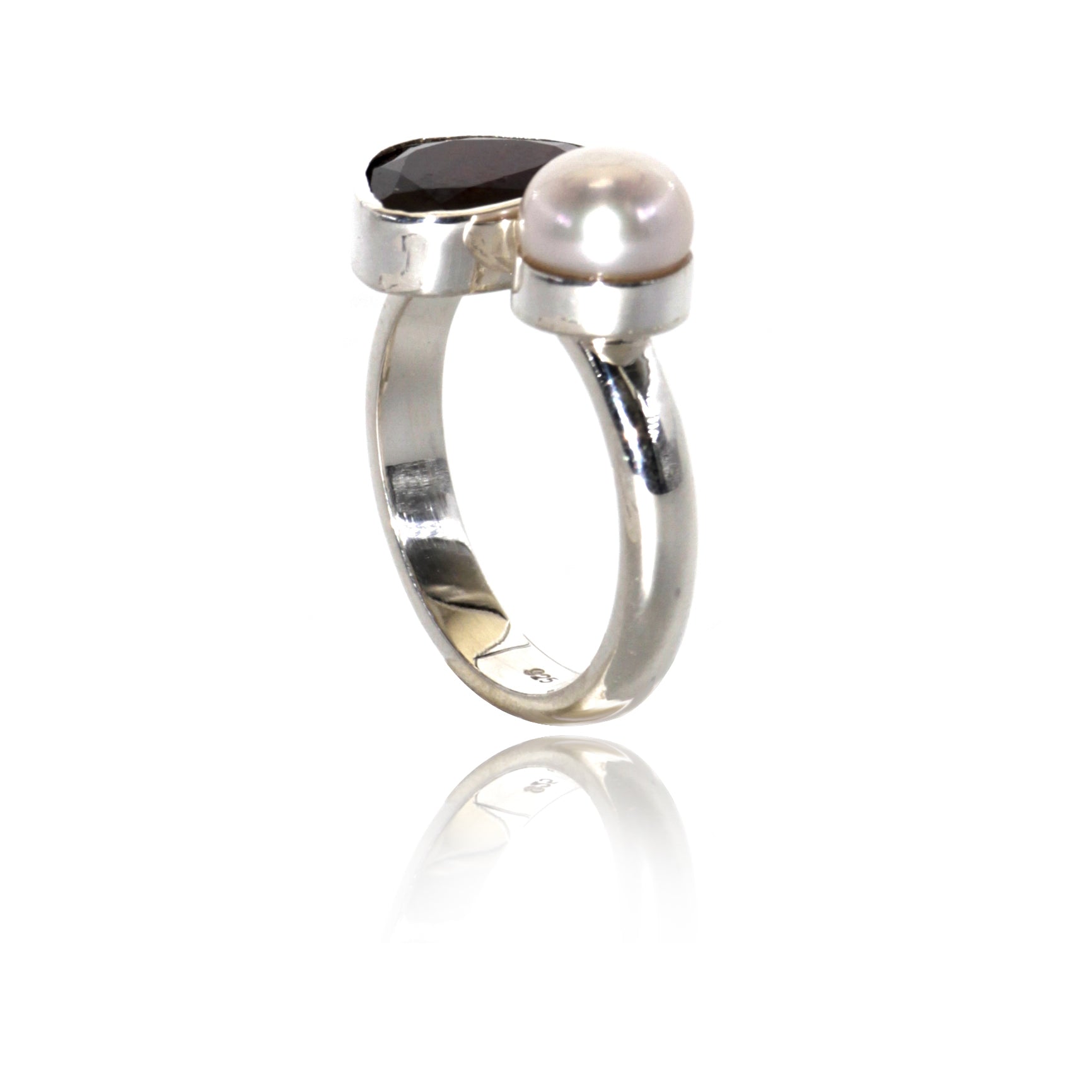 silver ring with garnet and pearl set in silver 925 side view on white background