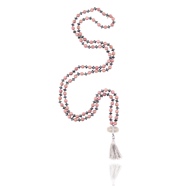 162 beads of 6 mm Faceted Rhodonite and Hematite and Crystal Clear Quartz pendant mala necklace on white background