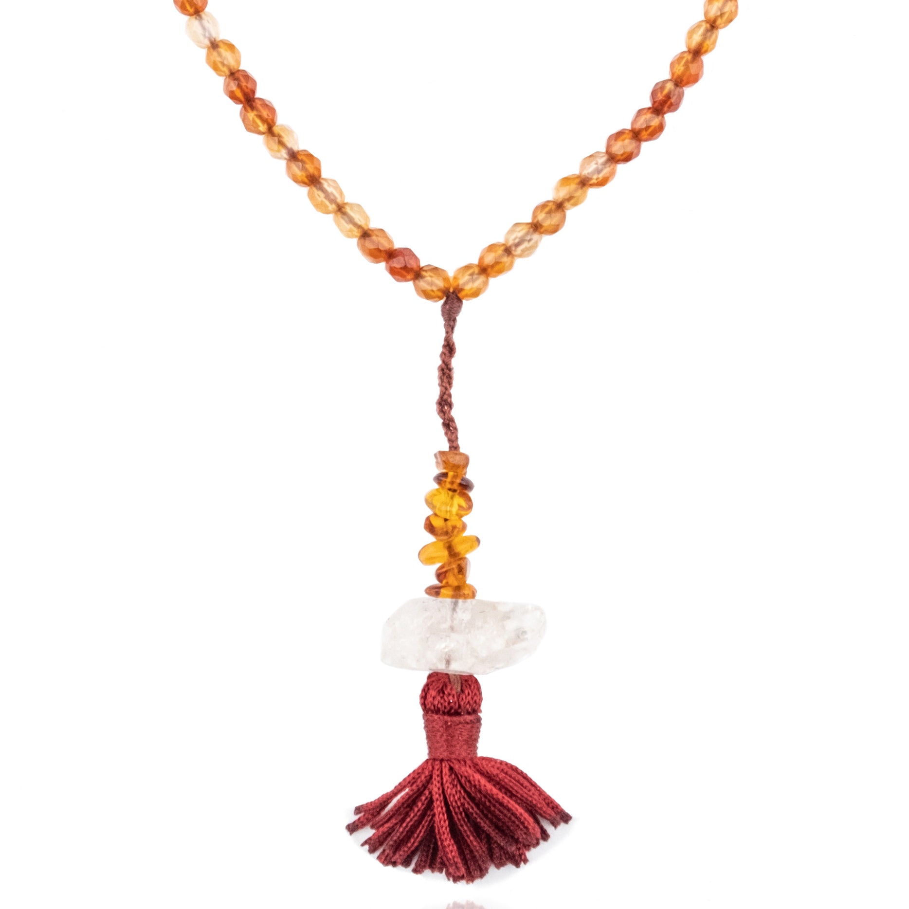 amber and herkimer diamond pendant of a mala necklace on white background