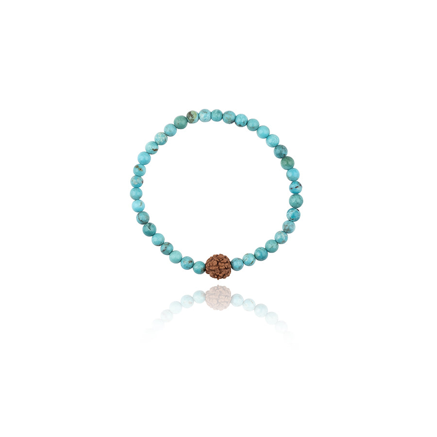 turquoise beads on elastic bracelet with rudraksa centerpiece on white background