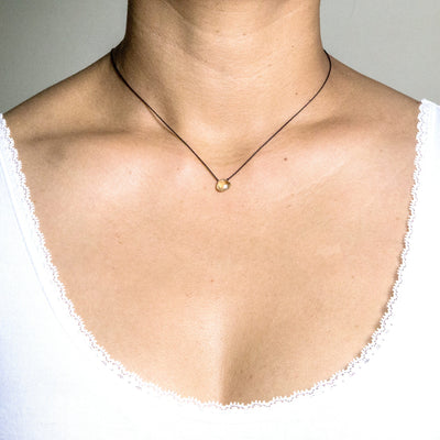 citrine drop on black artificial string with silver 925 clasp minimalist short necklace on model in white top