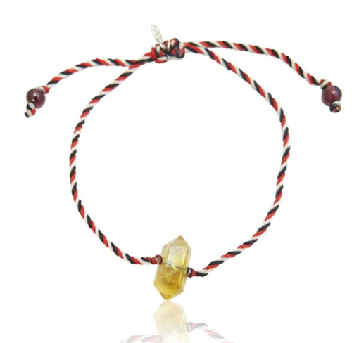 tri murti string bracelet with citrine centerpiece on white background