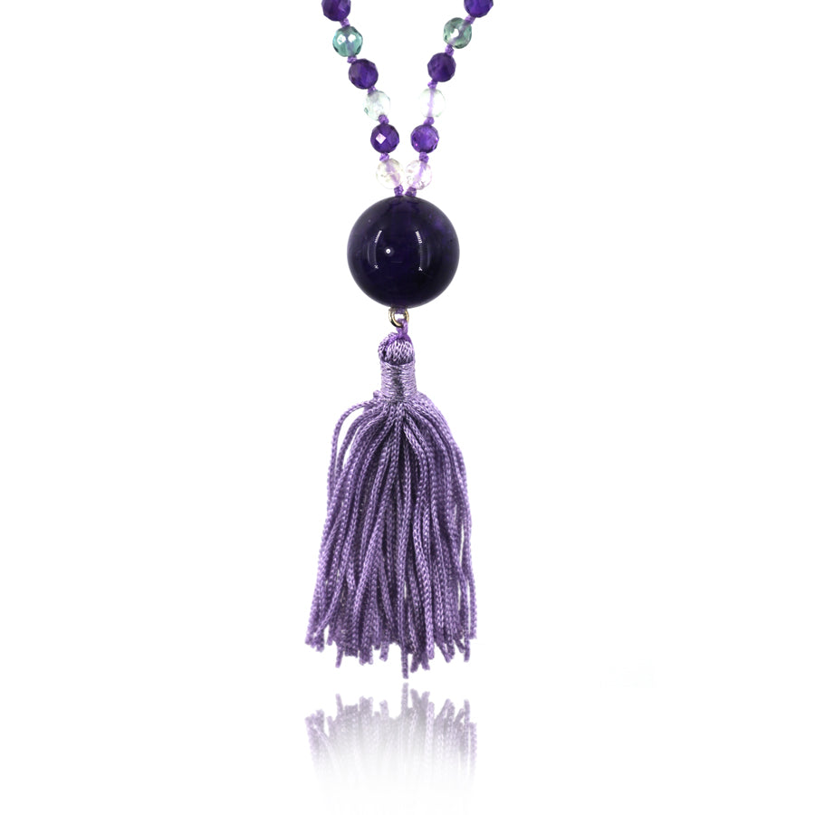 fluorite pendant and light purple tassel pendant on white background