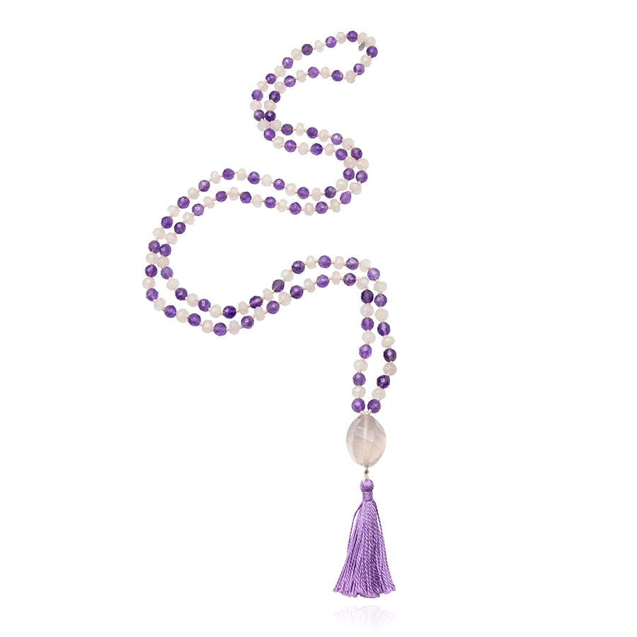 mala necklace with 6 mm faceted rose quartz and amethyst beads with rose quartz pendant and purple tassel on white background